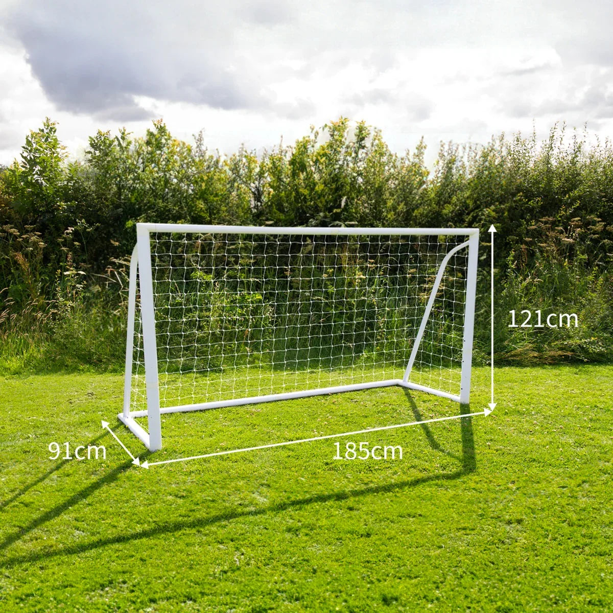 6 x 4ft white football goal with net, dimensions 185cm x 121cm x 91cm, set on green grass with trees in the background