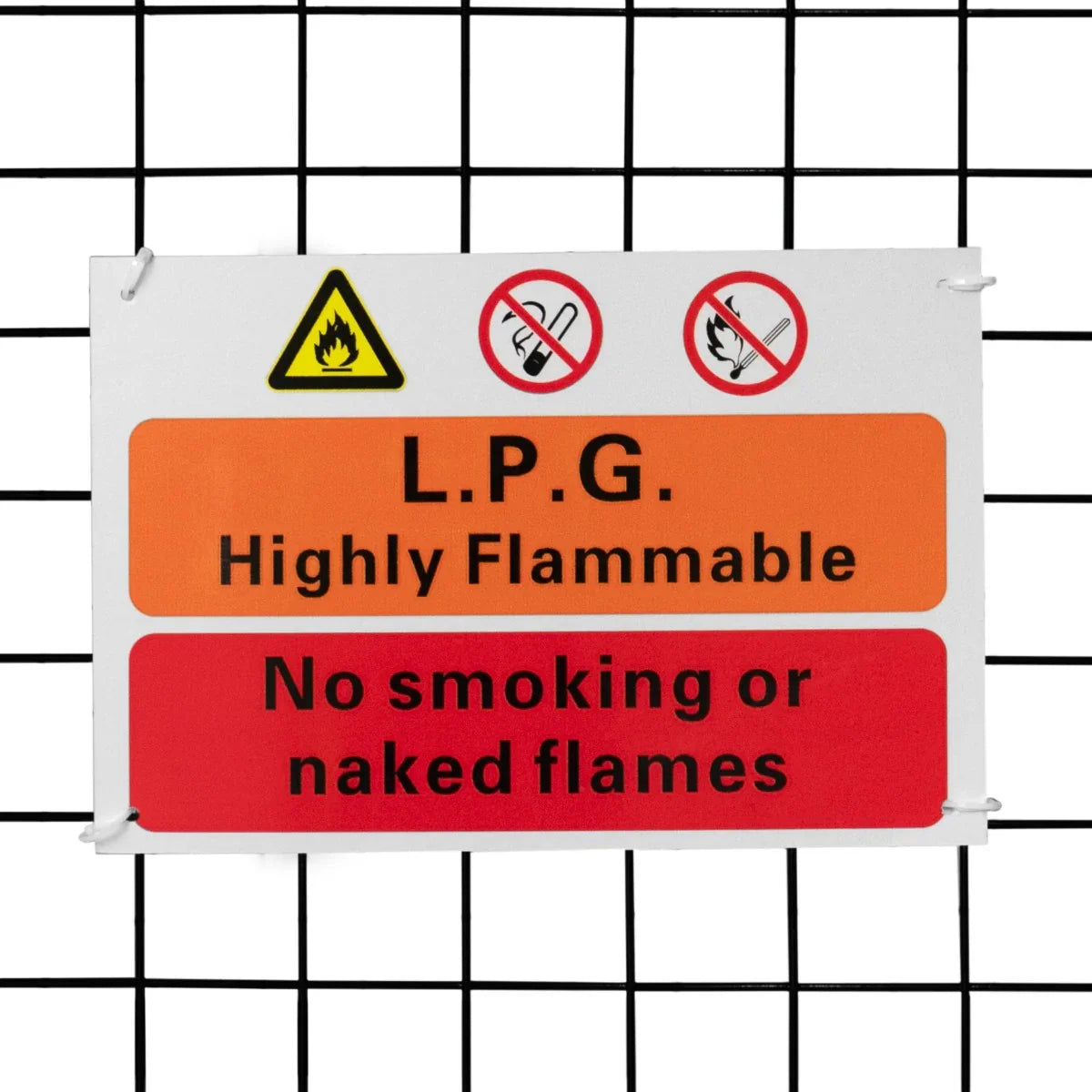 Bright safety sign on a white background, warning about LPG flammability, with symbols for fire and no smoking, attached to a mesh cage