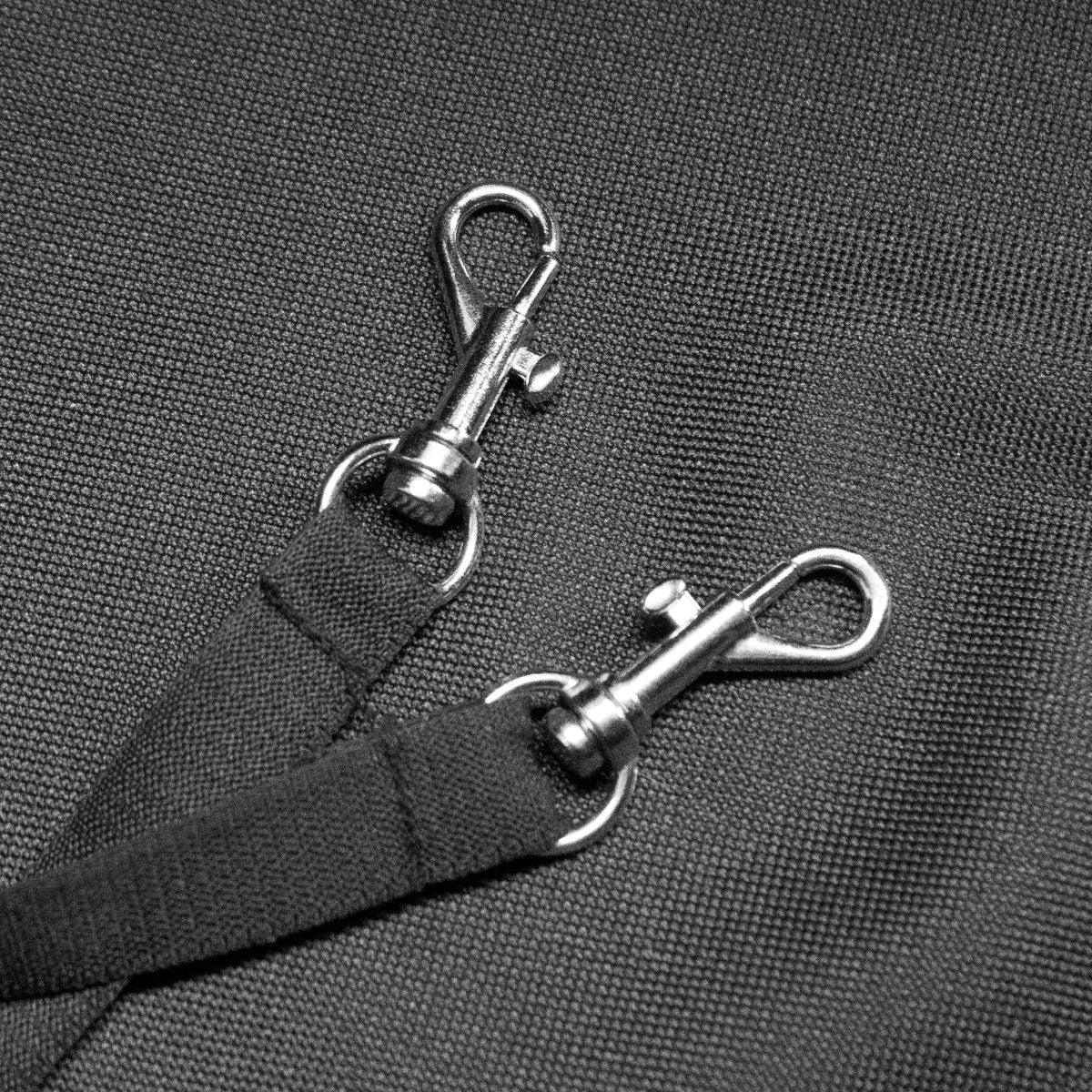 Close-up of durable metal clips on a black pet stroller, showcasing sturdy fabric and secure attachment points for safety