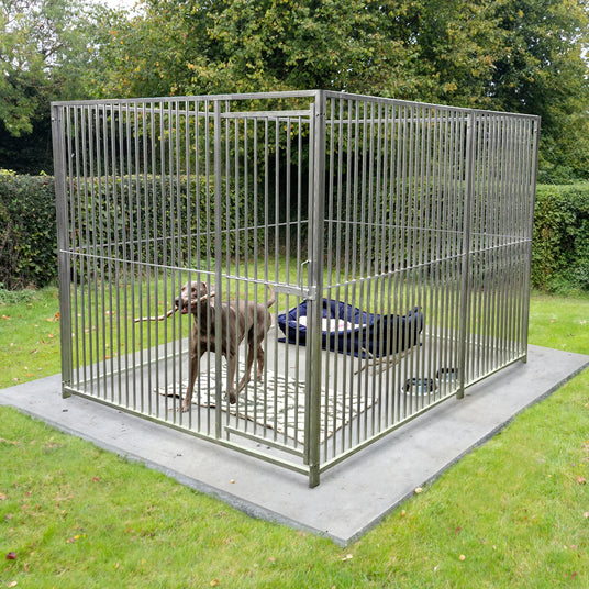 Sturdy outdoor dog kennel with metal bars, featuring a spacious interior and a comfortable dog bed on a grassy surface