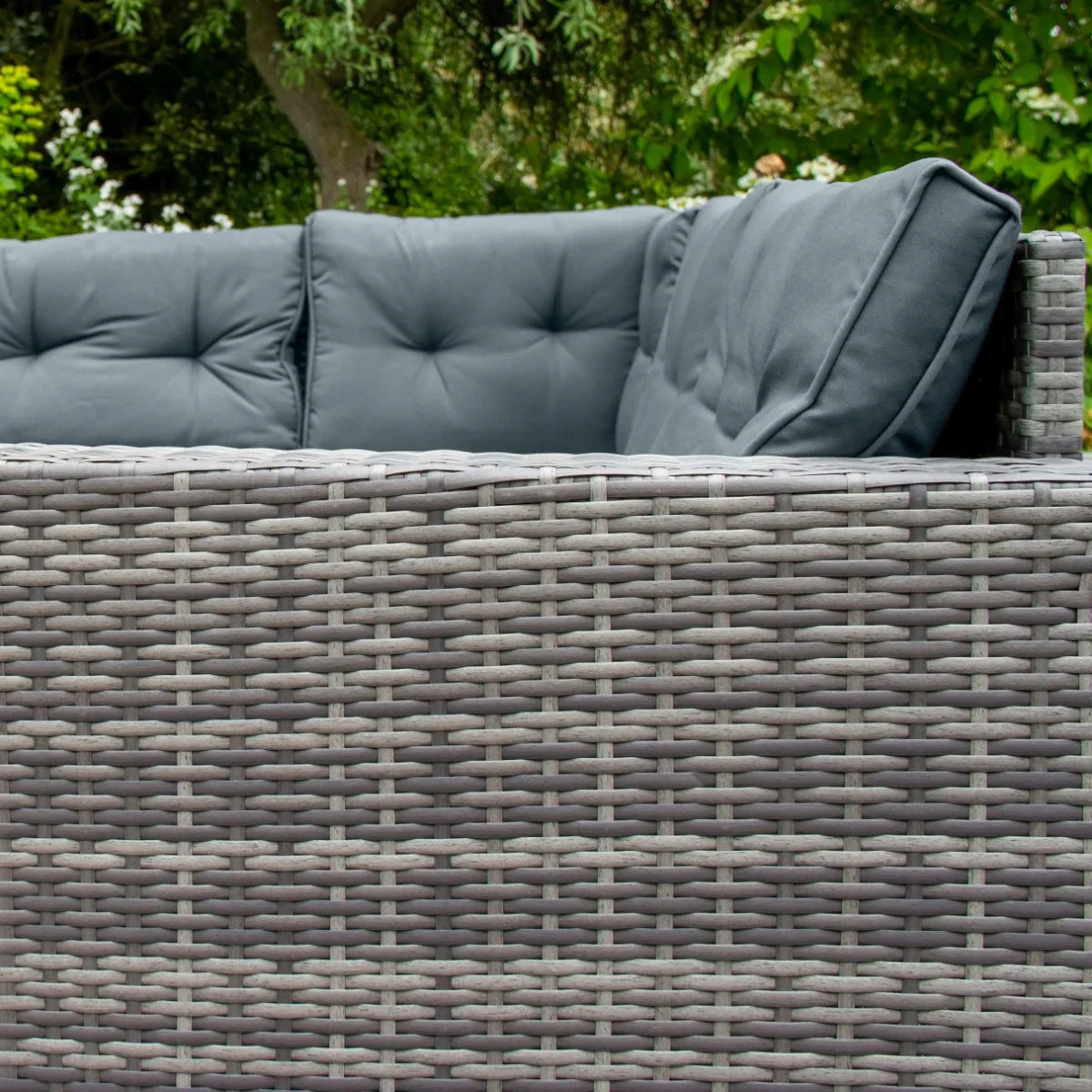 Grey rattan corner set featuring plush, tufted cushions and a woven texture, perfect for outdoor lounging and relaxation