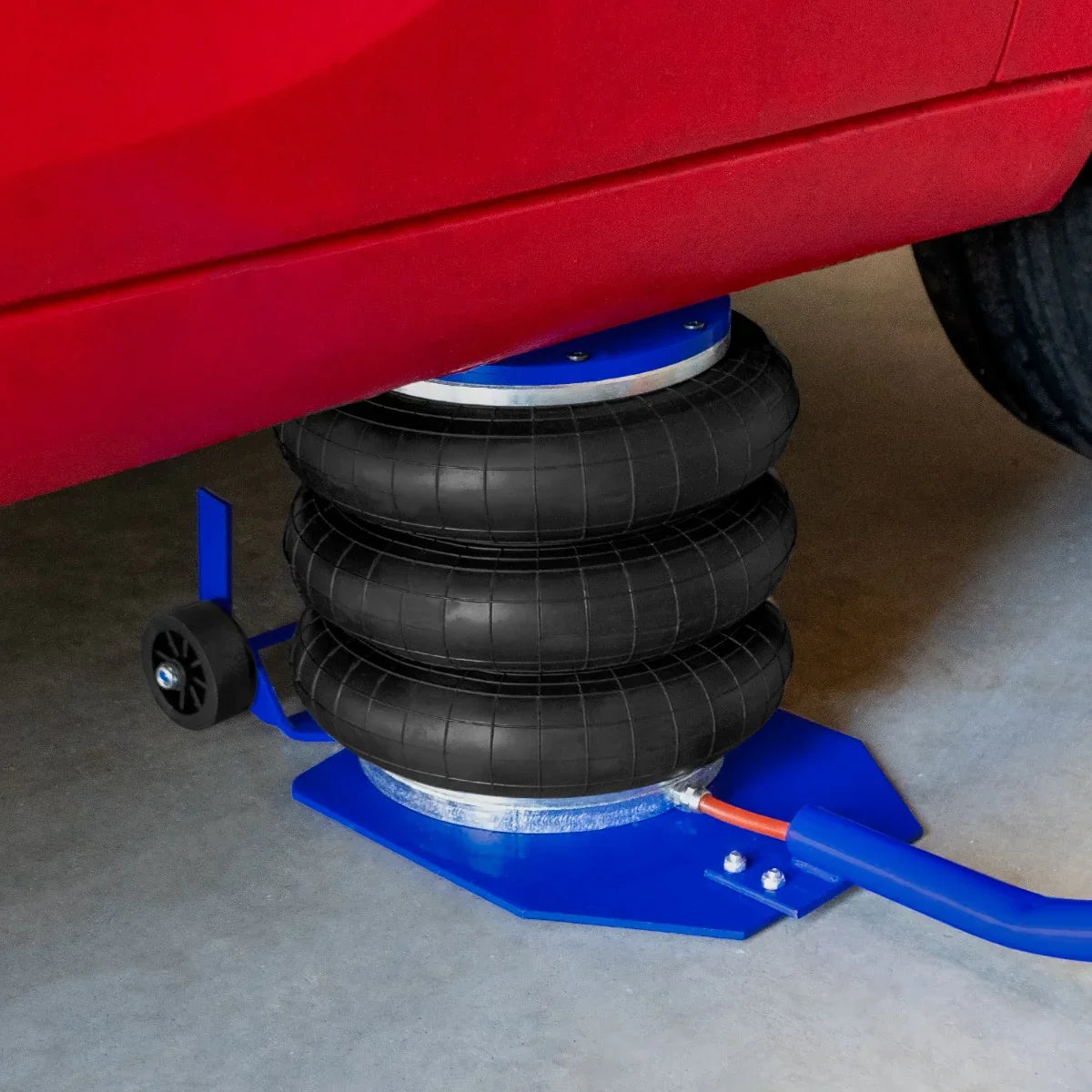 Air Bag Jack 3.5T with long lever handle, featuring three black rubber air bags, sturdy blue base, and red vehicle underneath