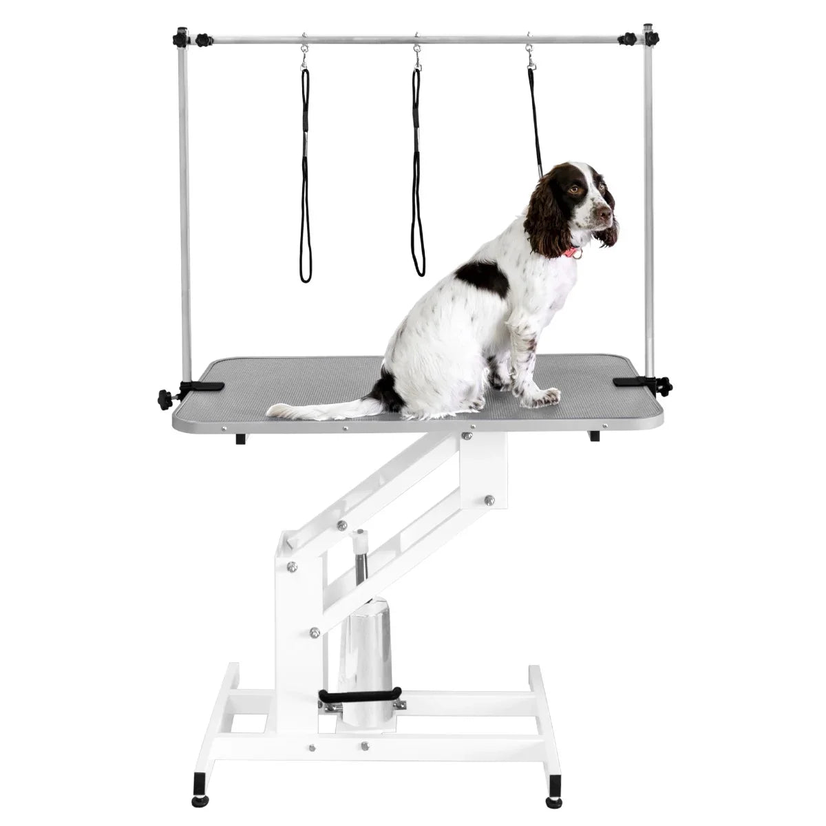 White hydraulic grooming table with a grey textured top, featuring adjustable height and safety restraints for pets