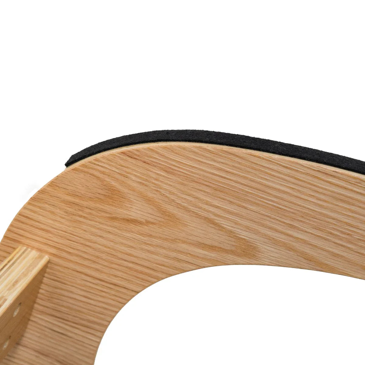 Curved wooden frame of an ergonomic kneeling chair with a soft black cushion, designed for comfort and support during sitting