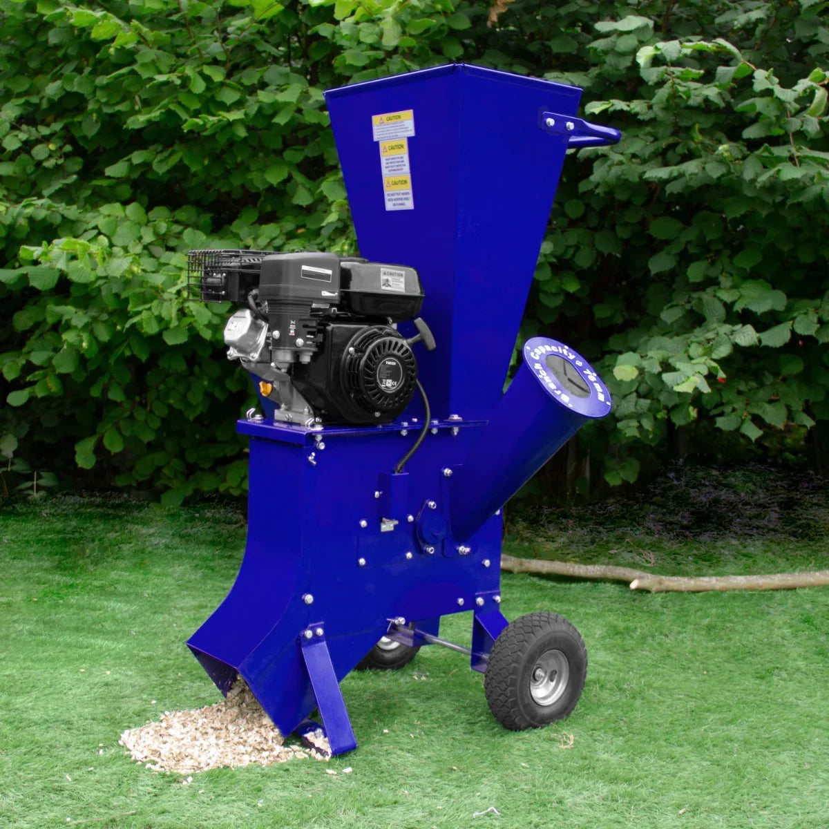 T-Mech 7HP wood chipper in vibrant blue, featuring a powerful engine, large hopper, and sturdy wheels for easy mobility on grass