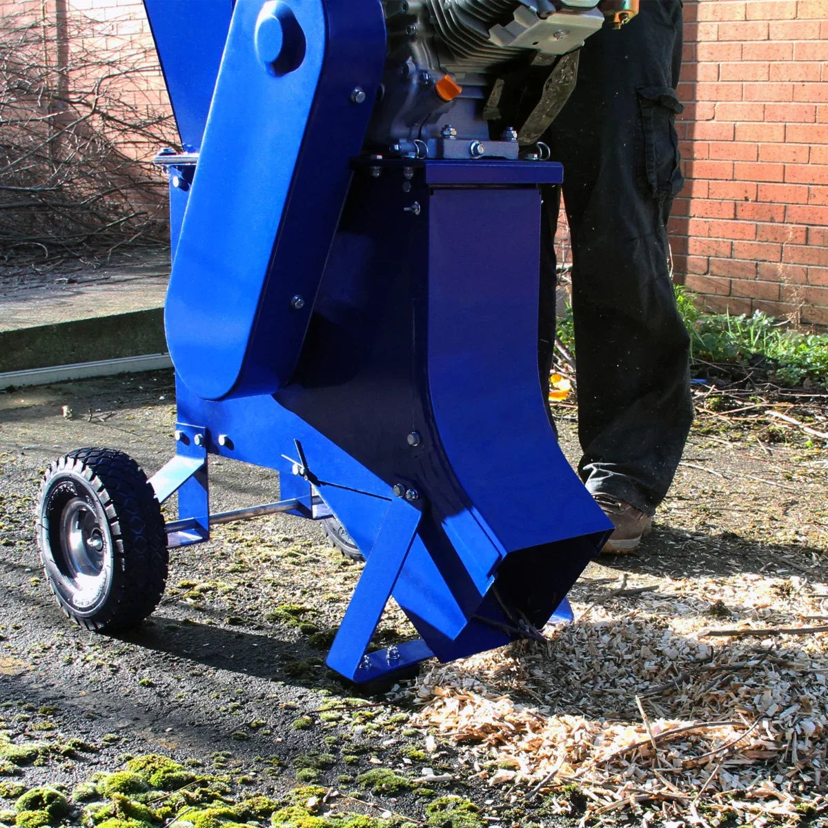 T-Mech 7HP wood chipper in vibrant blue, featuring a sturdy design, large wheel for mobility, and a wide chute for efficient wood processing