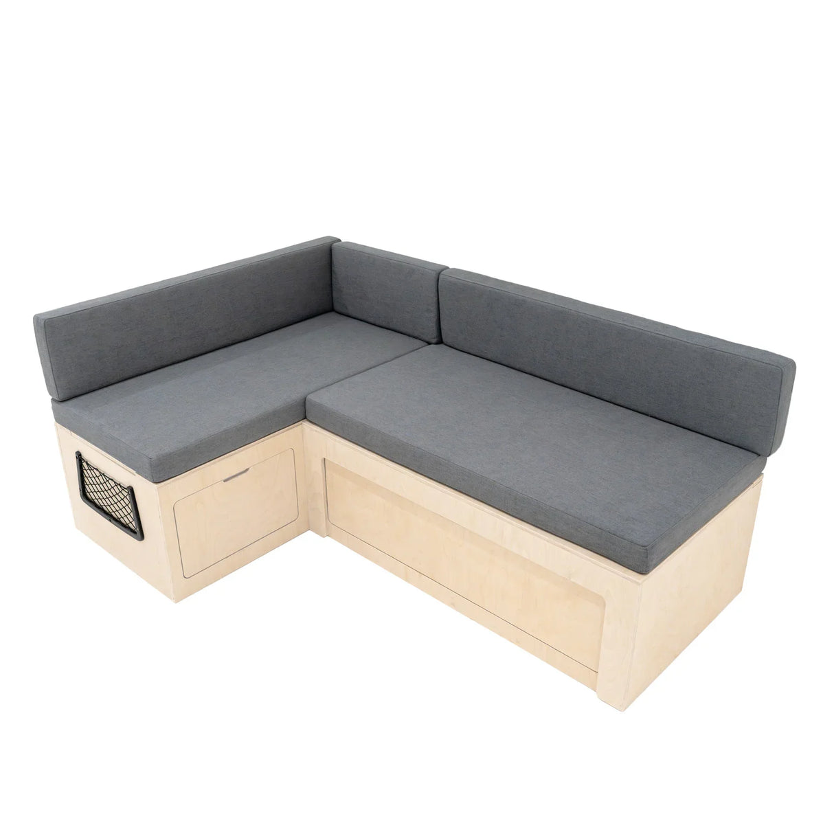 L-shaped camper van bed with a light wood frame and soft gray cushions, featuring storage drawers and a modern design