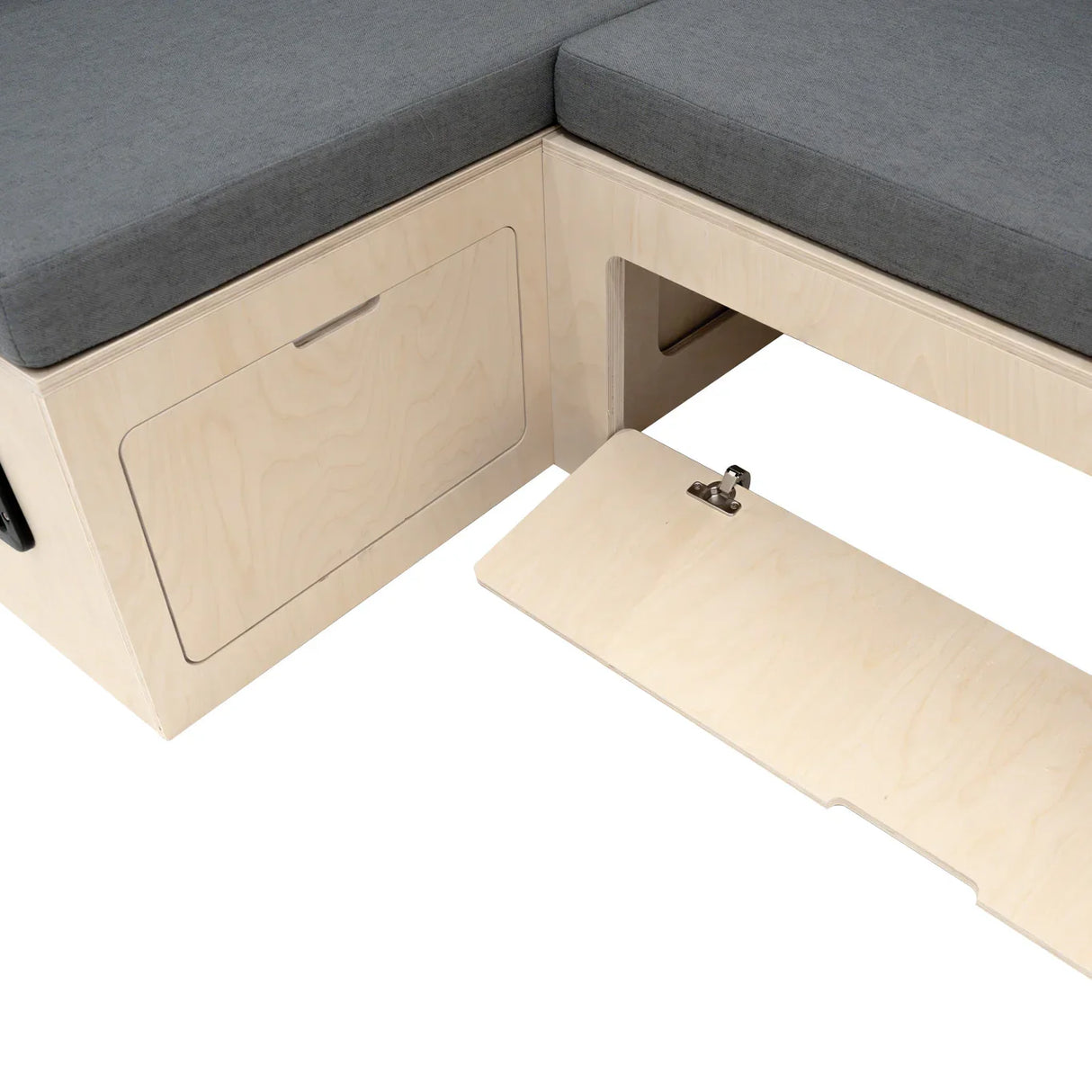 L-shaped camper van bed with gray cushioned top, light wood frame, and hidden storage compartment beneath the seating area