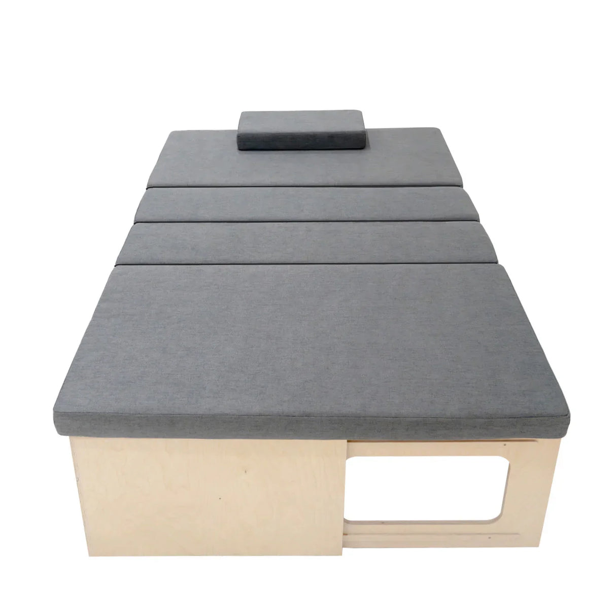 L-shaped camper van bed with gray fabric cushions, wooden base, and a compact design, ideal for maximizing space in small vehicles