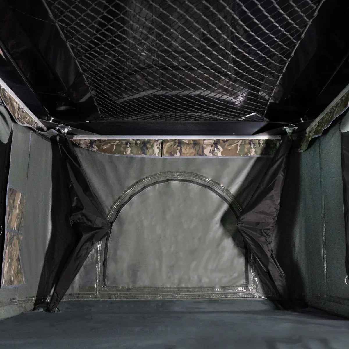 Spacious camouflage car roof tent interior featuring a durable waterproof fabric, mesh storage pockets, and a sleek design