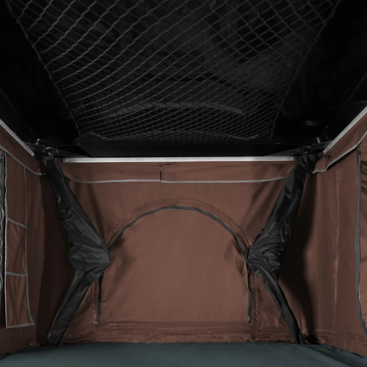 Spacious brown car roof tent interior featuring mesh storage pockets, durable fabric, and a large entryway for easy access