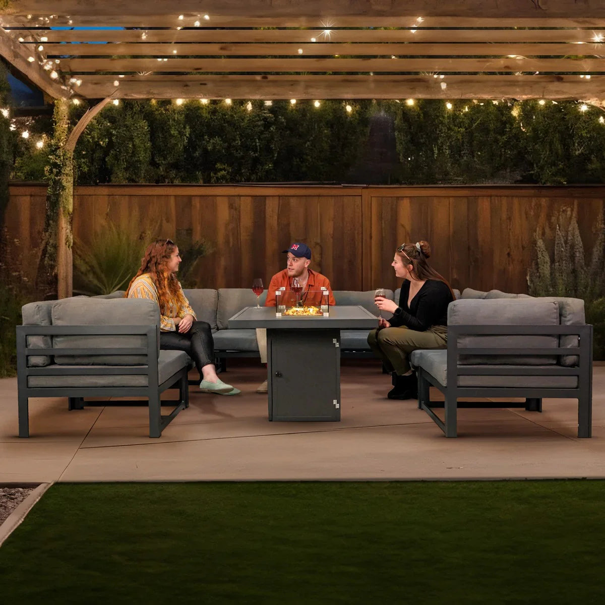 Modular garden furniture set in anthracite grey with plush cushions, featuring a central fire pit, perfect for outdoor gatherings