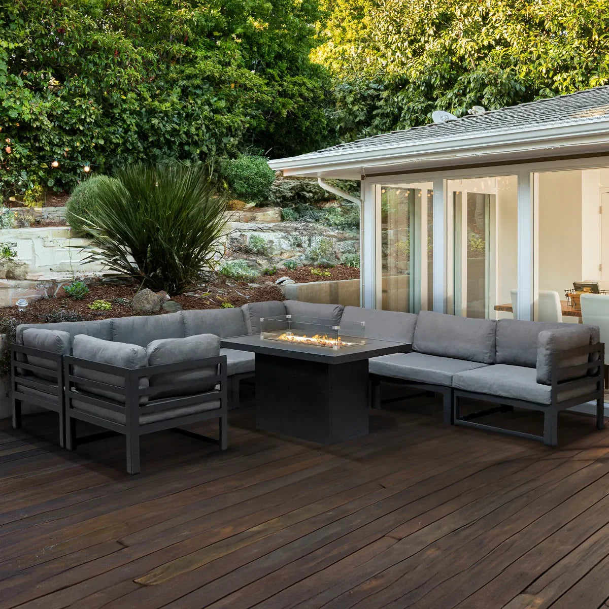 Modular garden furniture set in anthracite grey with plush cushions and a central fire pit, perfect for outdoor relaxation and gatherings