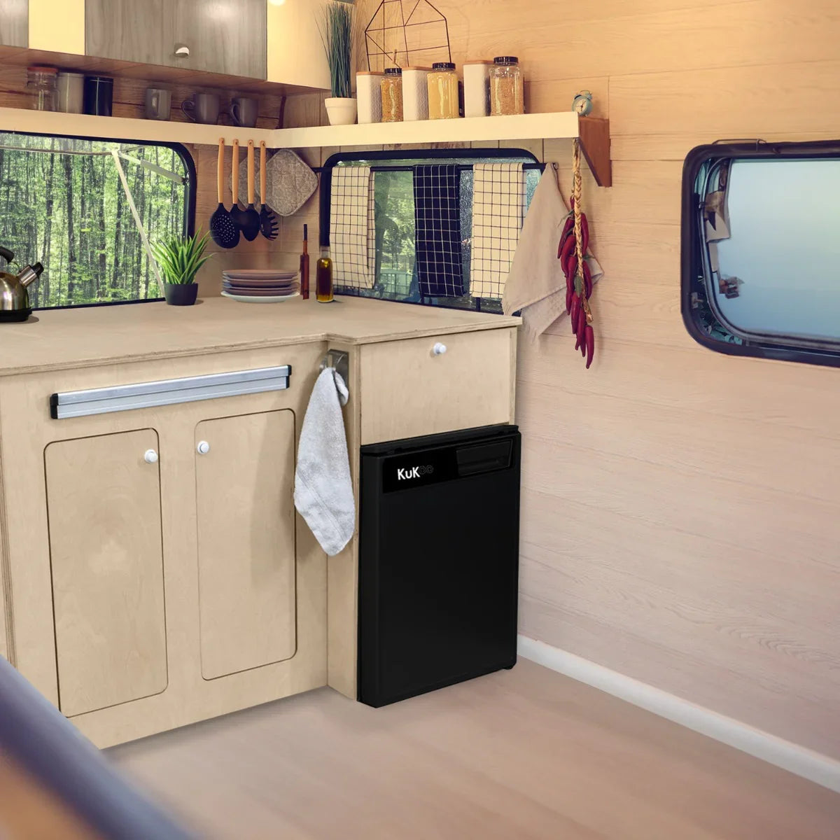 Camper Kitchen Pod - LHD features a sleek black fridge, light wood cabinetry, and a cozy, organized interior with natural light