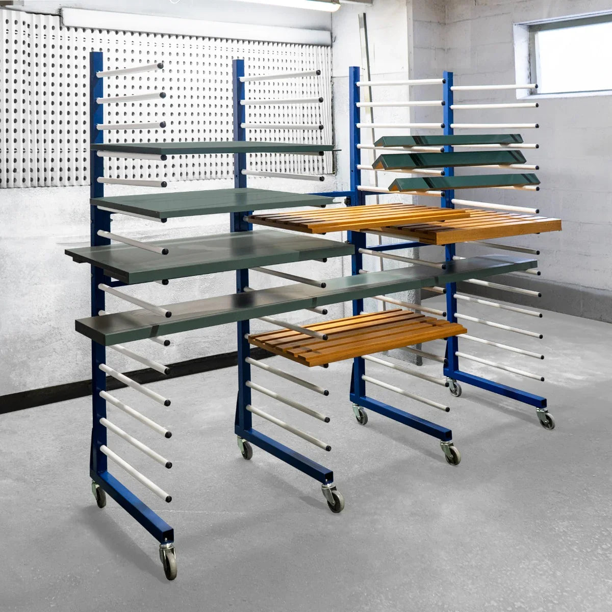 Combi Spray Drying Rack Trolley set with two trolleys, featuring blue metal frames, wooden shelves, and multiple drying rods on wheels
