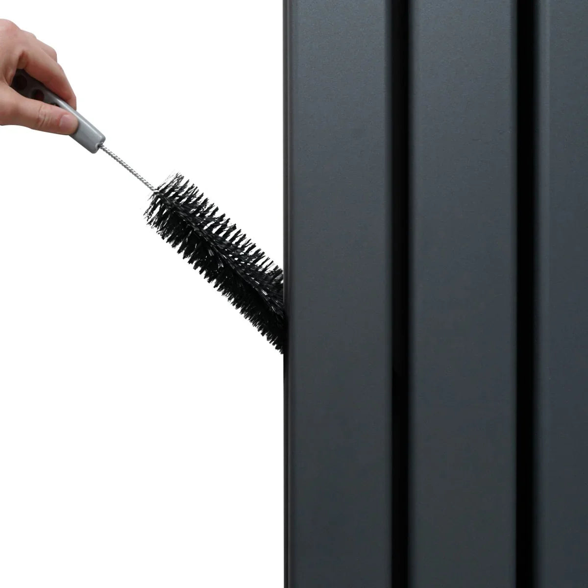 Anthracite grey flat mirror radiator with a hand using a cleaning brush on its textured surface, showcasing its sleek design
