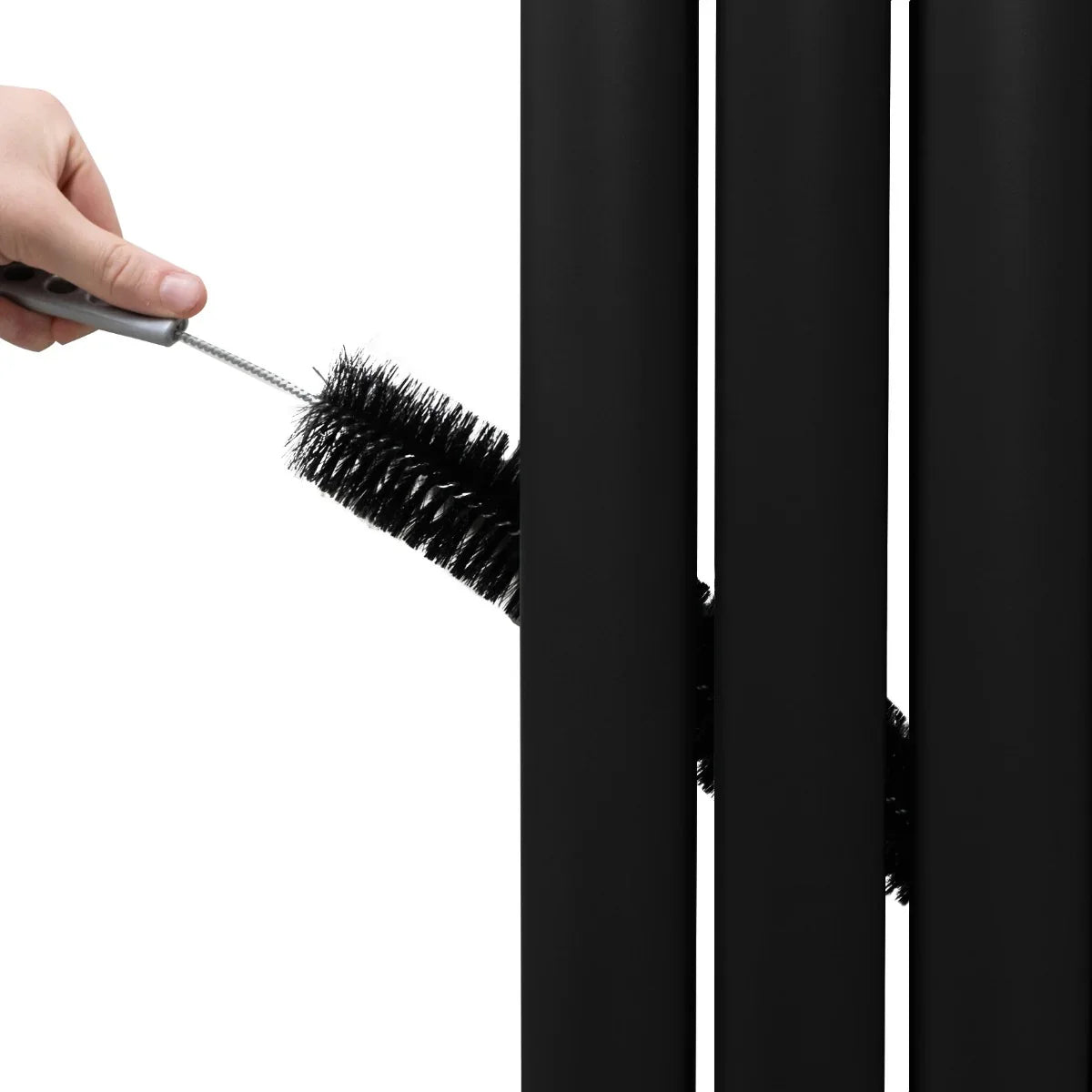 Black oval mirror radiator being cleaned with a brush, showcasing its sleek design and smooth matte finish, ideal for modern interiors