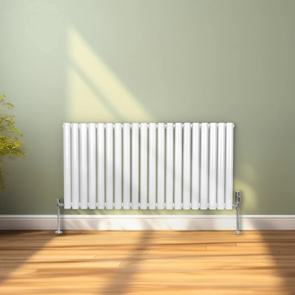 Sleek white oval column radiator, 600mm x 1200mm, featuring vertical fins and modern design, set against a soft green wall
