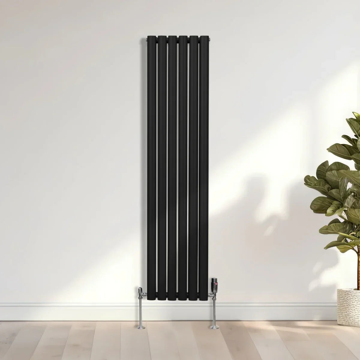 Sleek black oval column radiator, 1600mm x 360mm, featuring vertical bars and a modern design, mounted on a light wooden floor