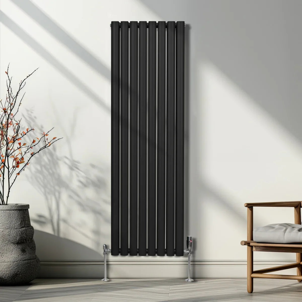 Sleek black oval column radiator, 1600mm x 480mm, featuring vertical lines and a modern design, installed against a light wall
