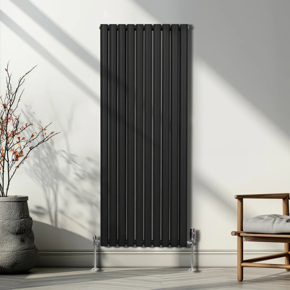 Sleek black oval column radiator, 1600mm x 600mm, mounted on a wall with modern decor, showcasing vertical lines and a minimalist design