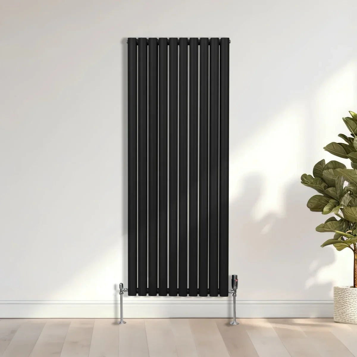 Sleek black oval column radiator, 1600mm x 600mm, featuring vertical bars and modern design, mounted on a light wooden floor
