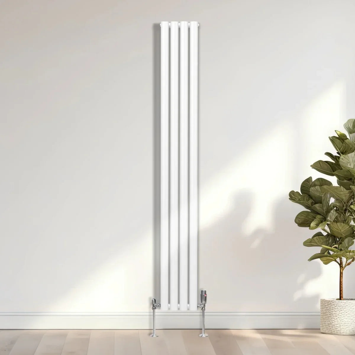 Sleek white oval column radiator, 1800mm x 240mm, featuring a modern design with vertical lines, set against a light wall and plant backdrop