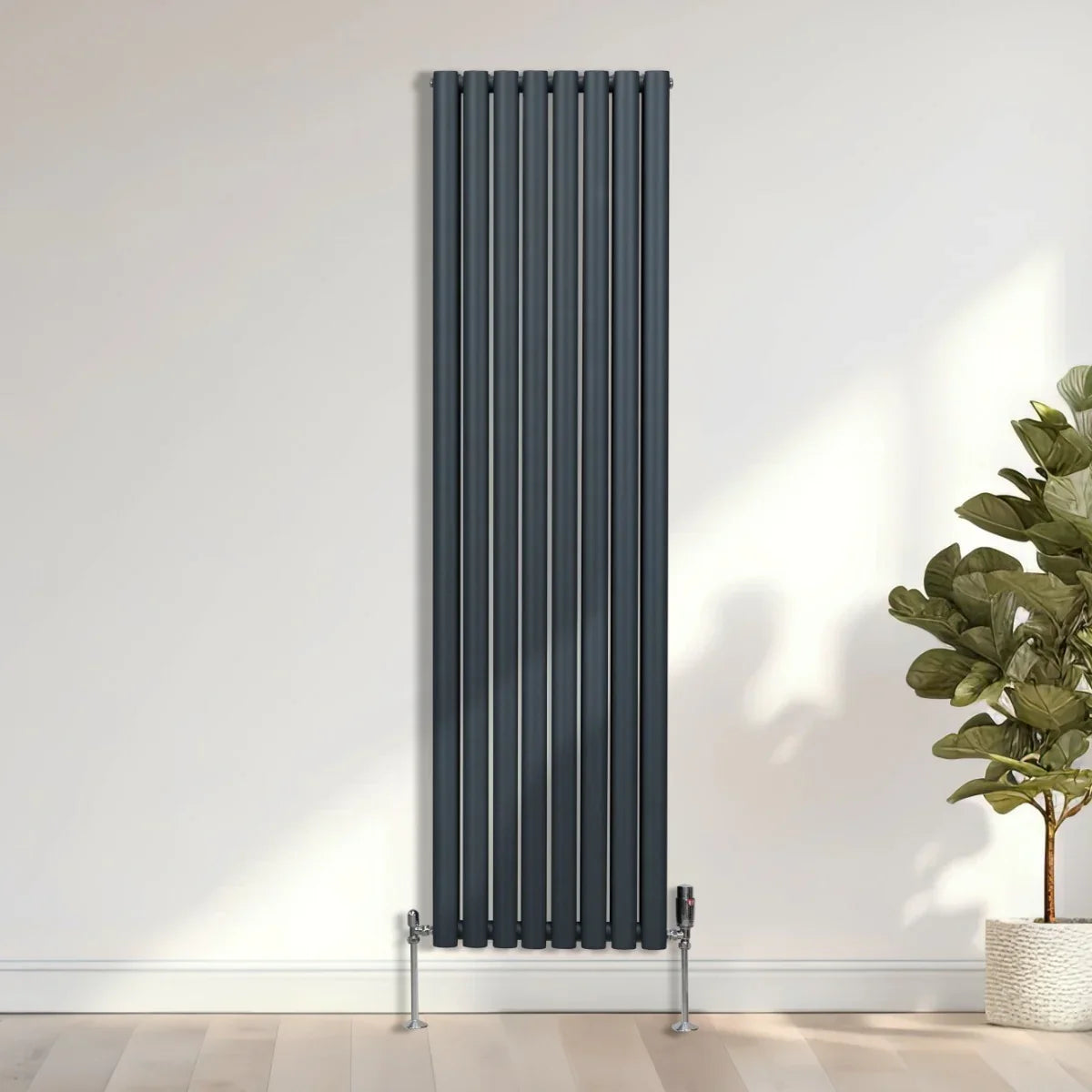 Oval column radiator in anthracite grey, 1800mm x 480mm, featuring sleek vertical lines and modern design, mounted on a light wall