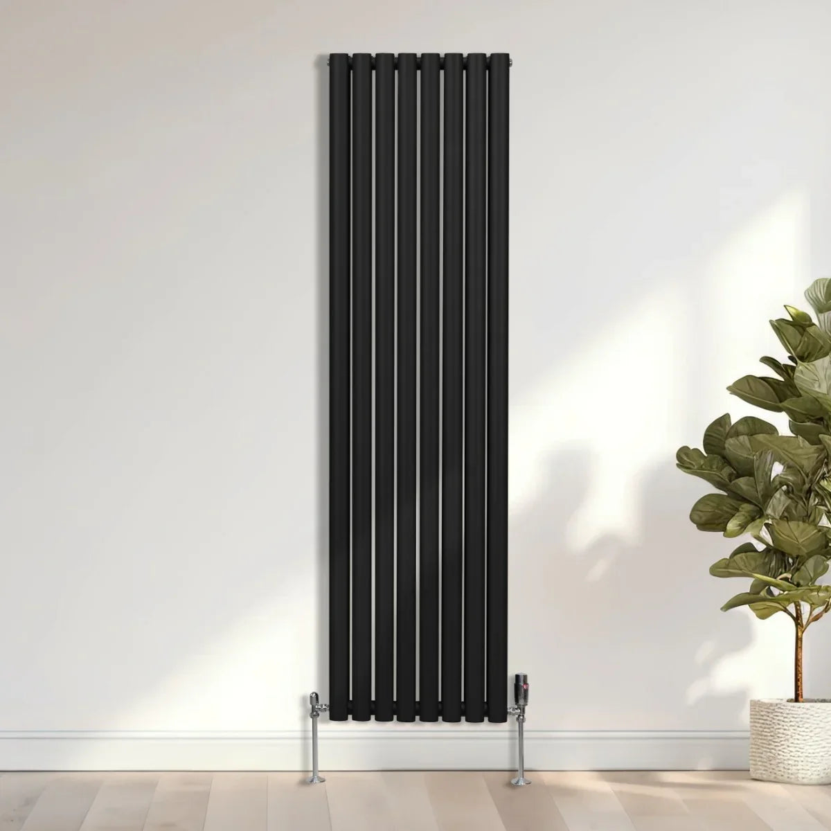 Sleek black oval column radiator, 1800mm x 480mm, featuring vertical lines and modern design, mounted on a light wooden floor