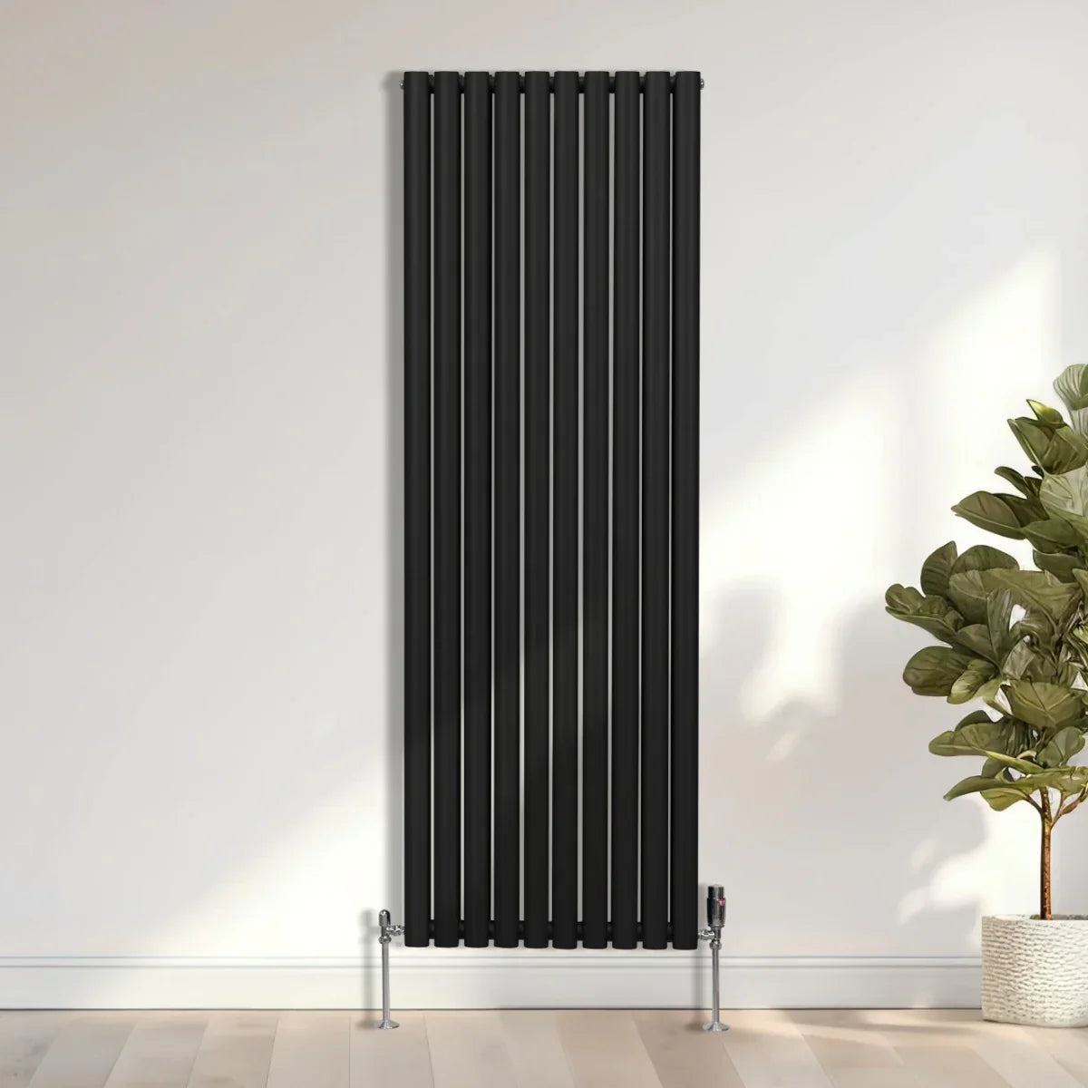 Sleek black oval column radiator, 1800mm x 600mm, featuring vertical lines and a modern design, mounted on a light wooden floor