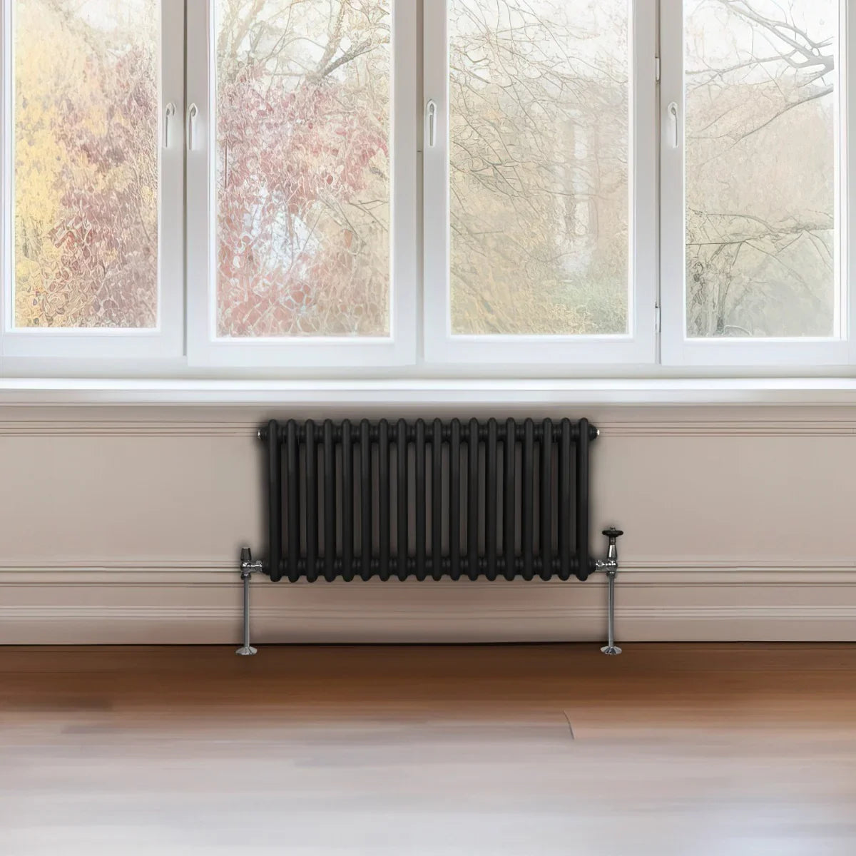 Traditional black 2 column radiator, 300 x 832mm, featuring a sleek design, mounted on a wall below large windows with natural light