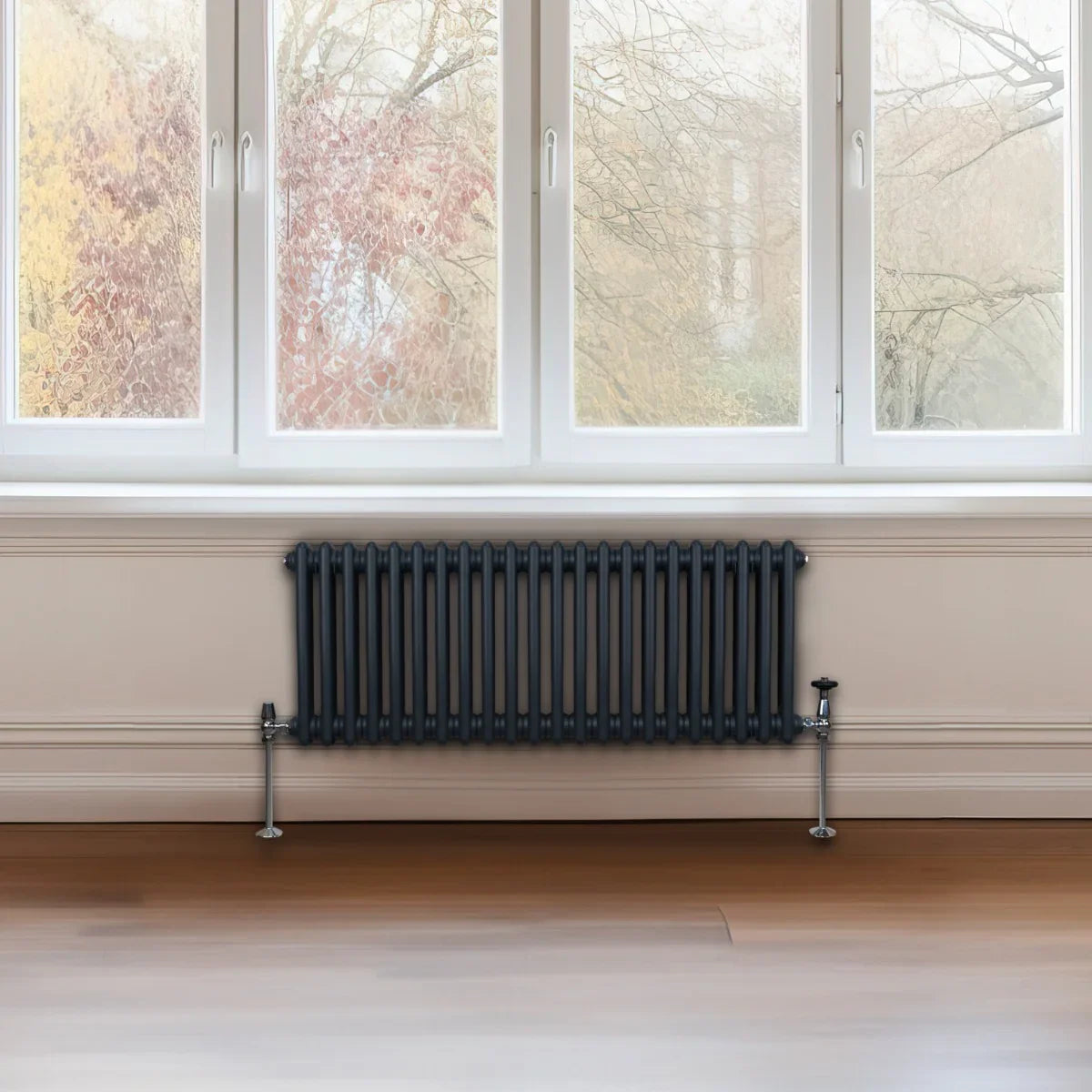 Traditional anthracite grey 2 column radiator, 300 x 1012mm, featuring a sleek design and smooth finish, installed beneath a large window