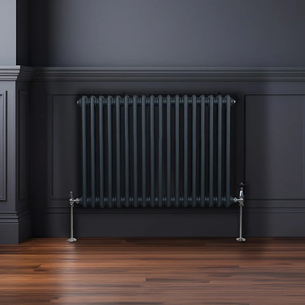 Traditional 2 column radiator in anthracite grey, featuring vertical bars and polished chrome valves, mounted on a dark wall