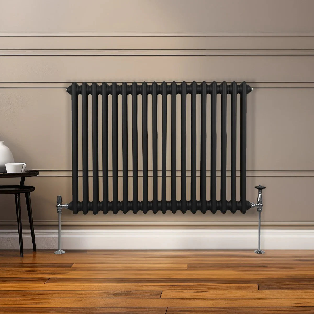 Traditional black 2 column radiator with a sleek design, mounted on a wall, complementing a modern interior with wooden flooring