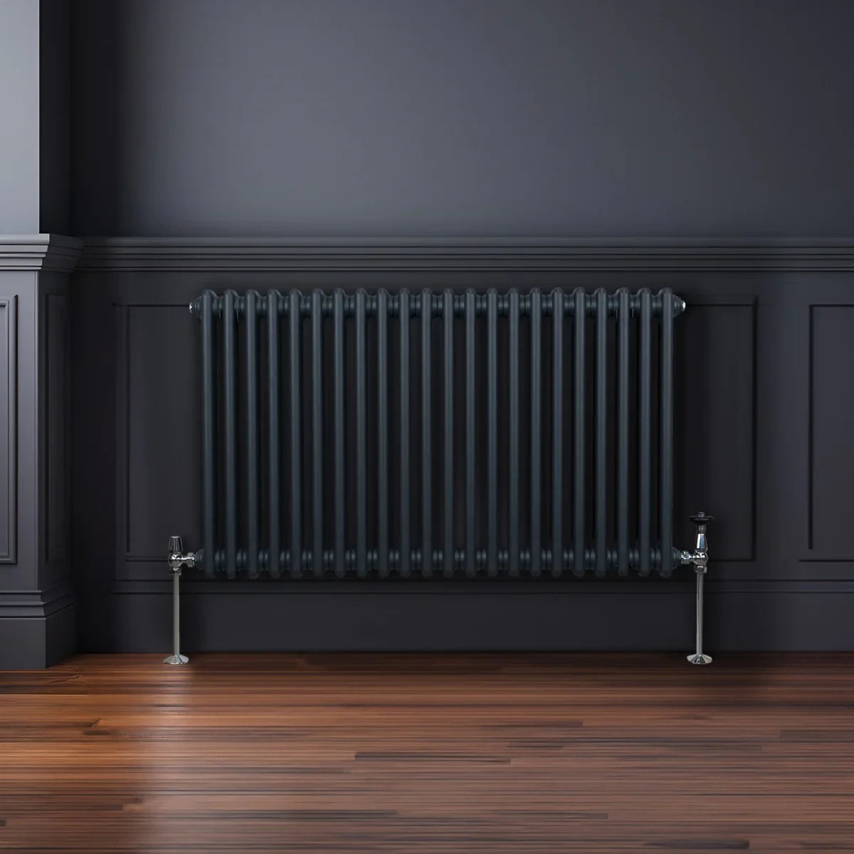 Traditional 2 column radiator in anthracite grey, featuring a sleek design with vertical bars, mounted on a wooden floor against a dark wall