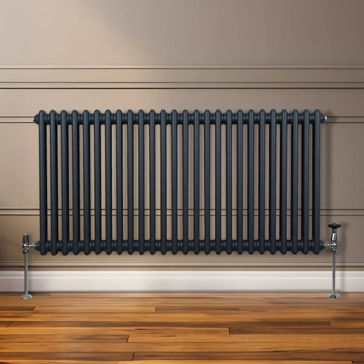 Traditional 2 column radiator in anthracite grey, featuring a sleek design with vertical tubes, mounted on a wooden floor against a wall