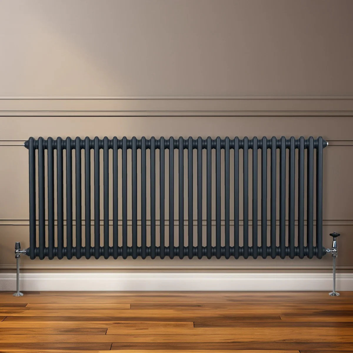 Traditional 2 column radiator in anthracite grey, featuring a sleek design with vertical bars, mounted on a wooden floor against a wall