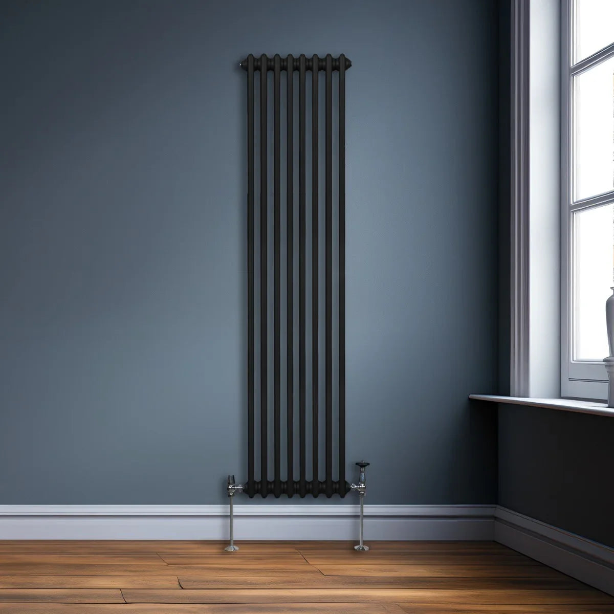 Traditional black 2 column radiator, 1800 x 382mm, featuring a sleek vertical design against a modern blue wall and wooden floor