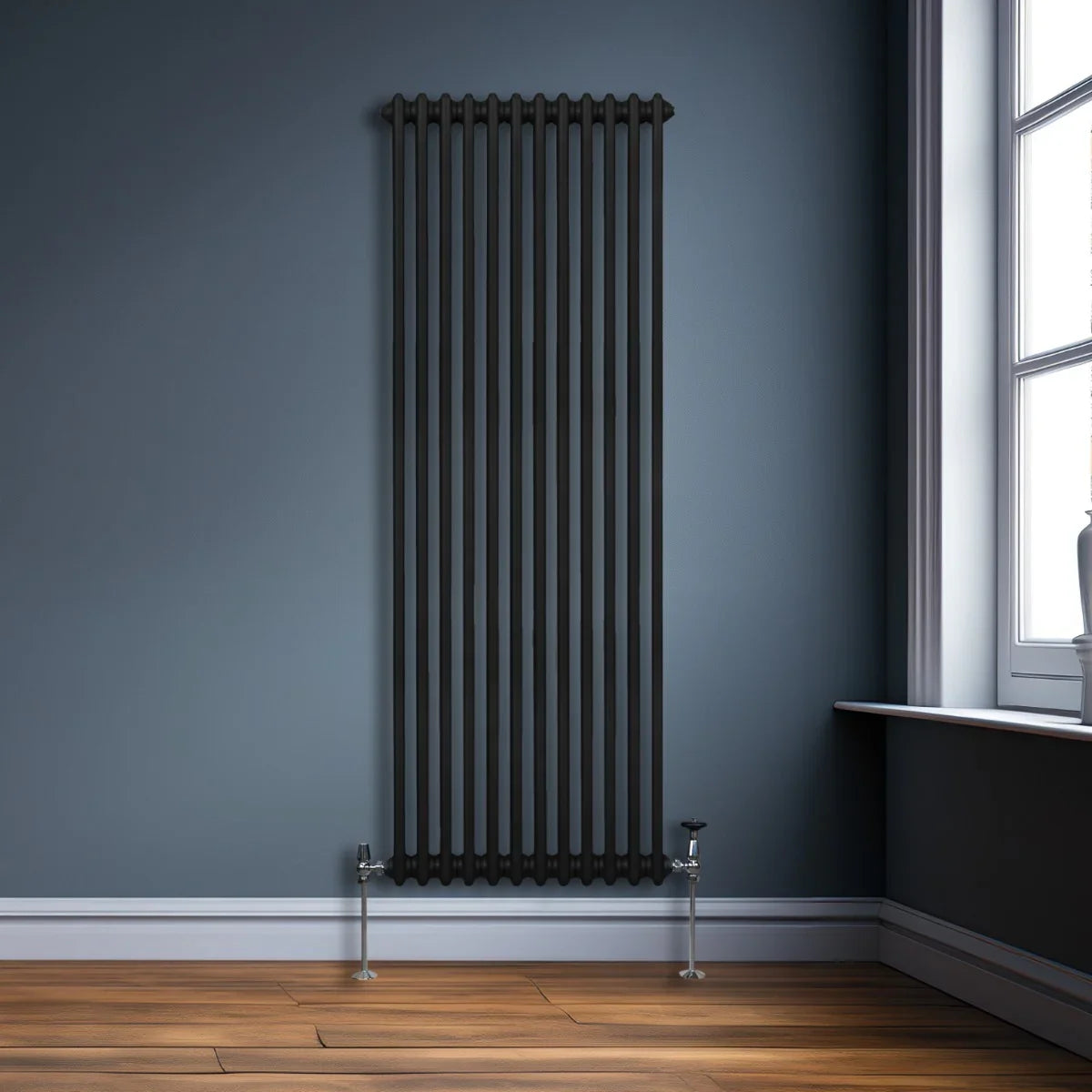 Traditional black 2 column radiator, 1800 x 562mm, featuring sleek vertical bars and polished chrome valves against a blue wall