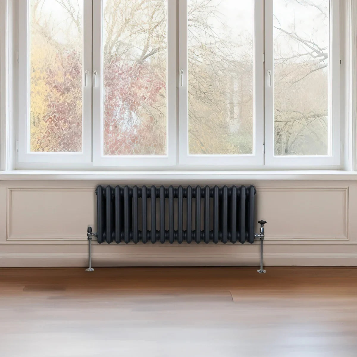 Traditional 3 column radiator in anthracite grey, featuring a sleek design with a smooth finish, positioned beneath large windows