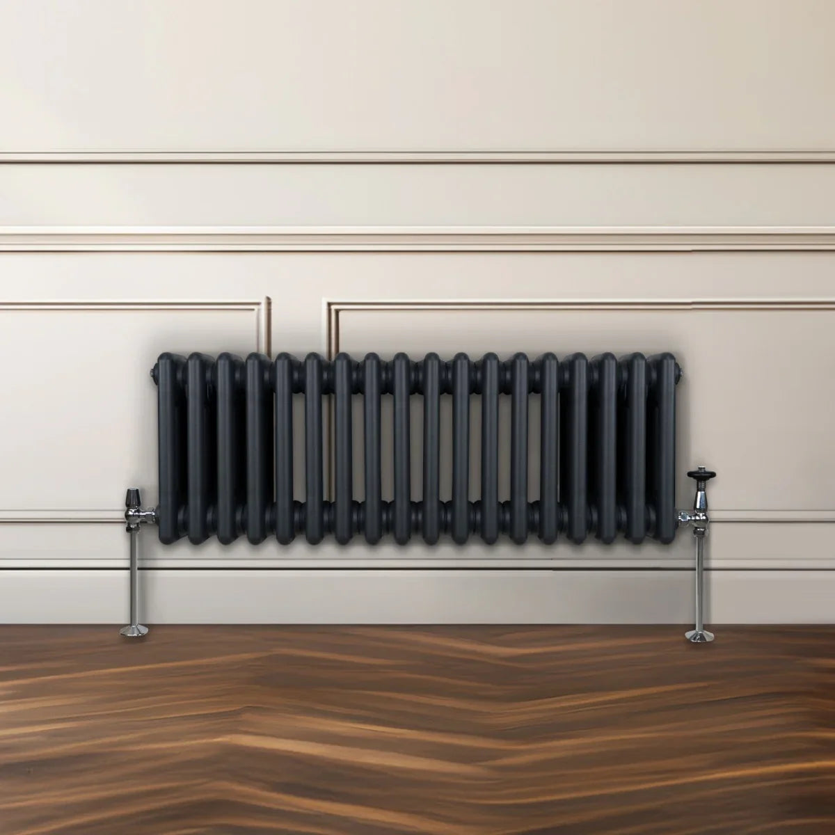 Traditional 3 column radiator in anthracite grey, featuring a sleek design with rounded edges, mounted on a wall above a wooden floor