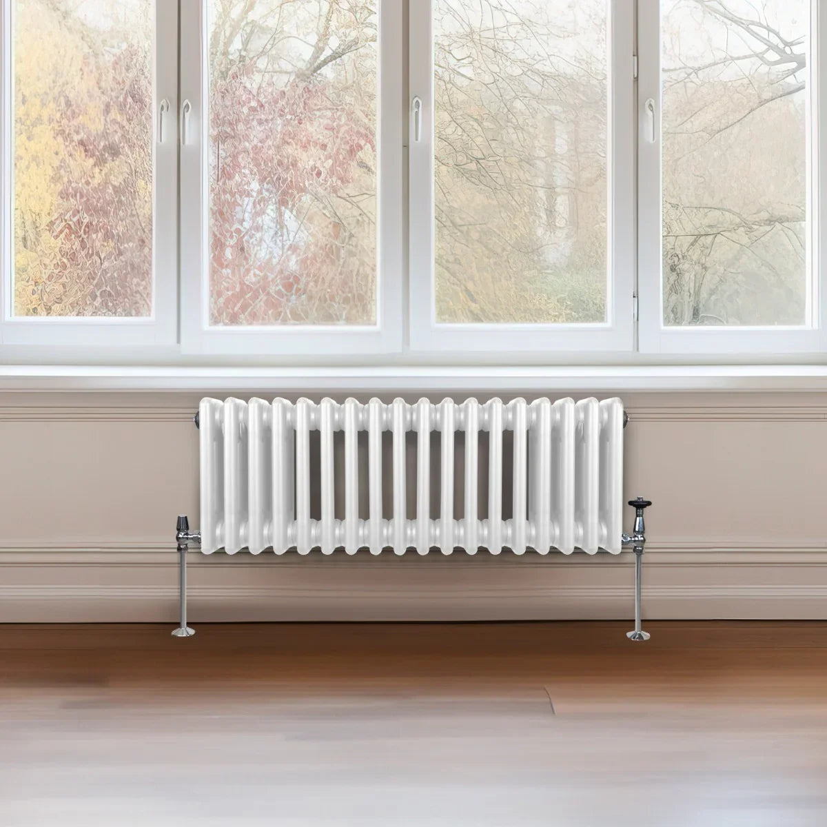 Traditional 3 column radiator in white, featuring a sleek design with vertical fins, installed beneath a large window in a modern room
