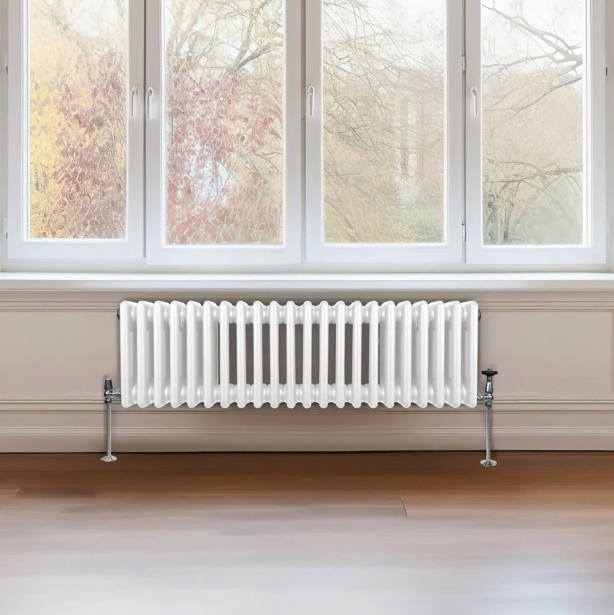 Traditional white 3 column radiator, 300 x 1192mm, featuring a glossy finish and sleek design, installed beneath a large window