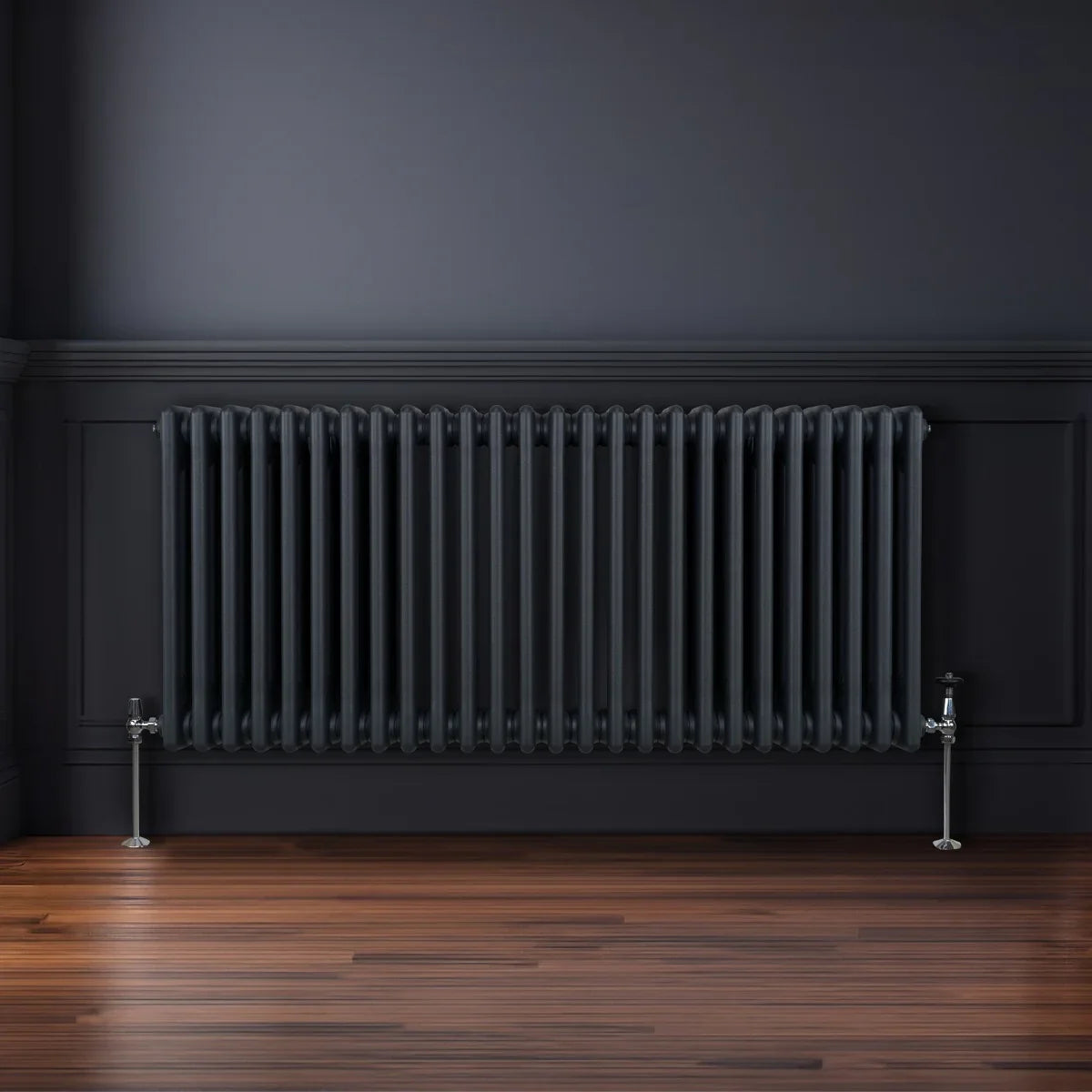 Traditional 3 column radiator in anthracite grey, featuring a sleek design with vertical bars, mounted on a dark wall above wooden flooring