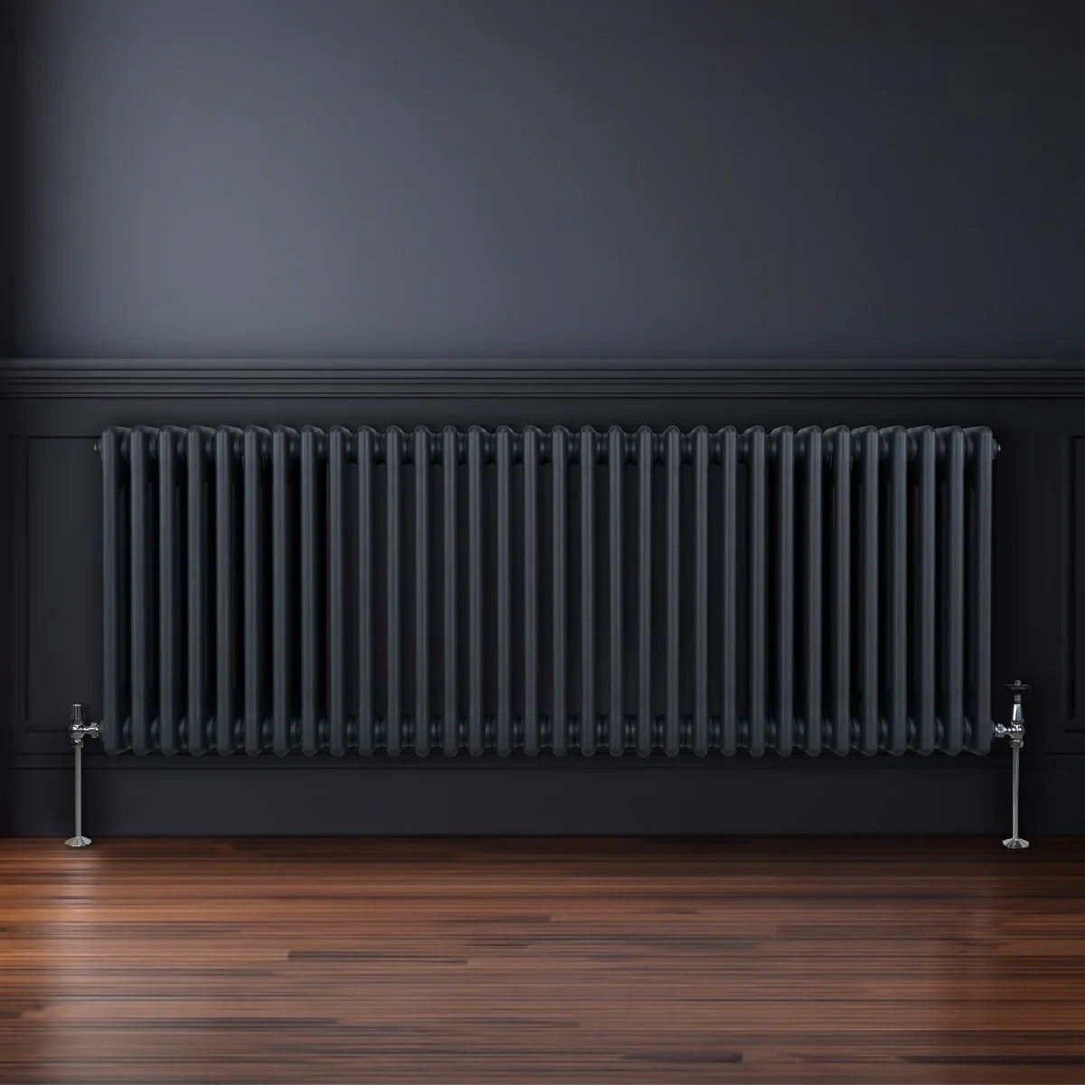 Traditional 3 column radiator in anthracite grey, featuring sleek vertical lines and polished silver feet, set against a dark wall