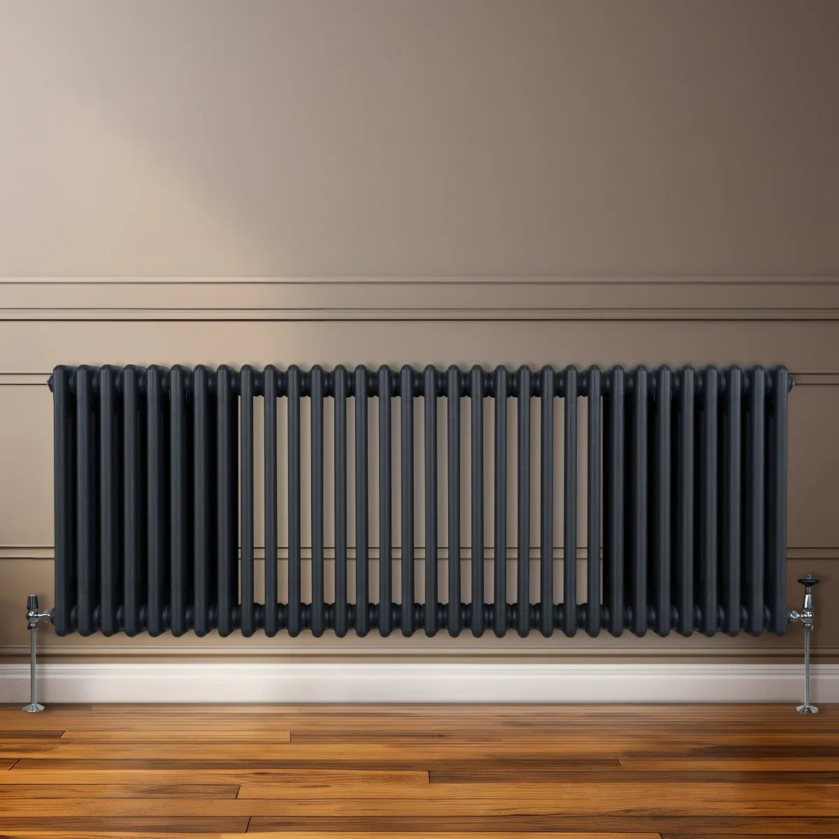 Traditional 3 column radiator in anthracite grey, featuring a sleek, ribbed design and mounted on a wooden floor against a neutral wall