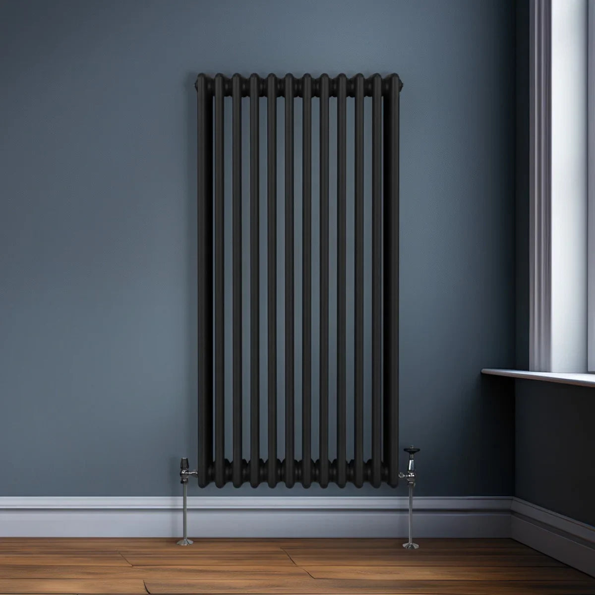 Traditional black 3 column radiator, 1500 x 562mm, featuring a sleek design with vertical tubes and stylish valves, set against a blue wall