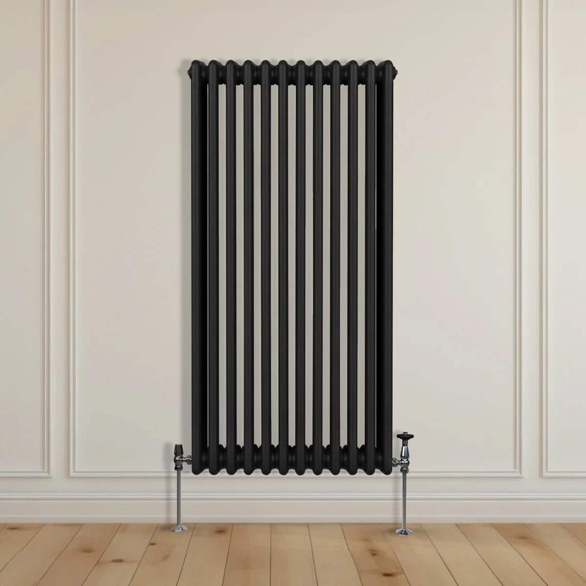 Traditional black 3 column radiator, 1500 x 562mm, featuring a sleek vertical design and polished chrome valves against a light wall and wooden floor