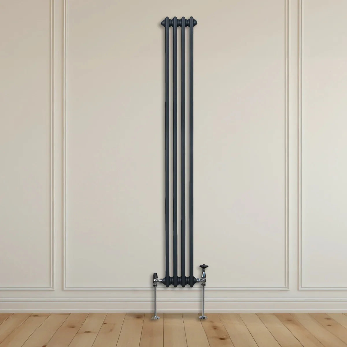 Traditional 3 column radiator in anthracite grey, featuring a sleek vertical design against a light wall and wooden floor