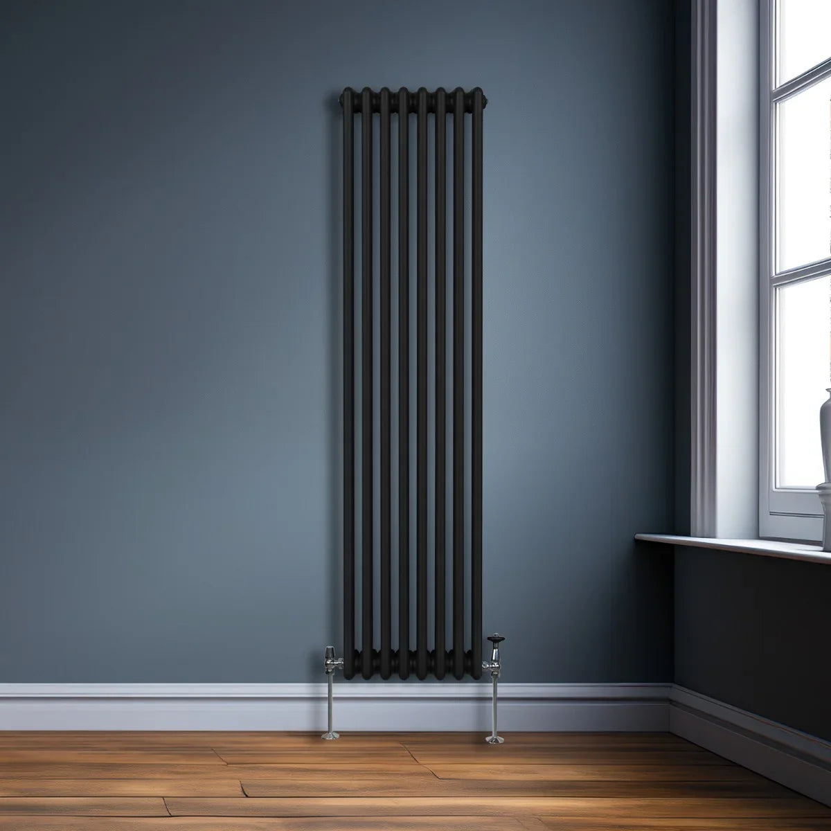 Traditional black 3 column radiator, 1800 x 382mm, featuring a sleek design against a blue wall and wooden floor, ideal for modern spaces